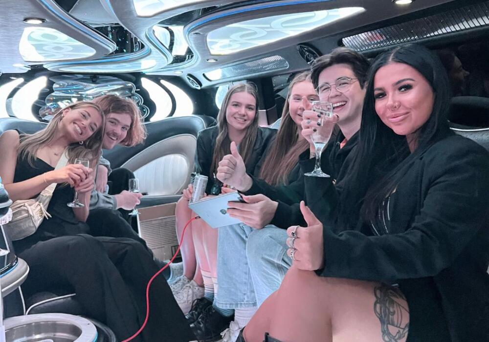Group Celebrating In A Limousine