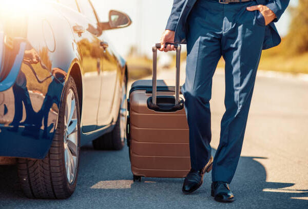 Traveling Businessman With His Luggage Near Car.